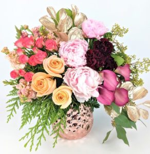 peach roses pink calla lilies and greens in copper pot