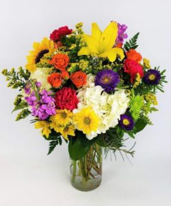 locally with fresh flowers. of sunflowers daisies yellow pink green and white floral accents